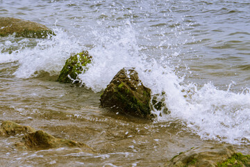 water splashes over rocks 