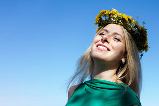 Young woman with flowers wreath on head.