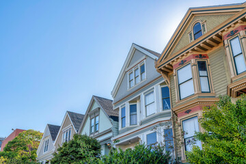Fototapeta na wymiar Slanted low angle view of houses with decorative shingles and bay windows at San Francisco, CA