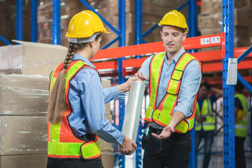 Worker team wrapping boxes in stretch film at warehouse, Worker wrapping stretch film parcel on pallet in factory warehouse
