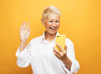 Photo of elderly woman wear short blond hair use smartphone
