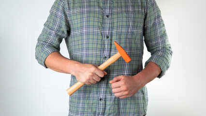 A man with a hammer in his hands on a white background