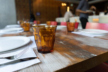 Glass with restaurant table place setting