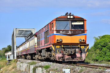 Obraz premium Passenger train by diesel locomotive on the railway in Thailand