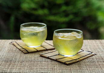 Cold Japanese green tea placed in a place with a view of the garden.