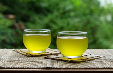 Cold Japanese green tea placed in a place with a view of the garden.