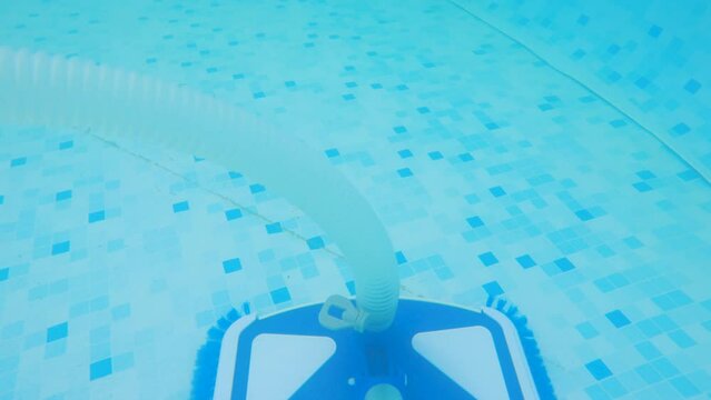 The bottom of the pool is cleaned with a vacuum cleaner brush. Water flow sucks in debris and sand. Maintenance and care for your home pool. Underwater filming