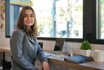 portrait young business woman  working casually in indoors cafe.