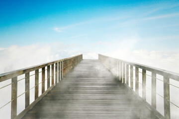 Fototapeta na wymiar Eempty wooden bridge with blue sky background