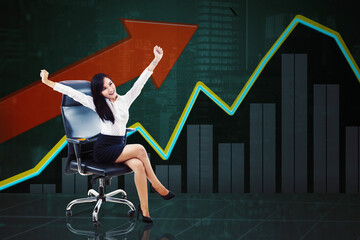 Fototapeta premium Happy businesswoman sitting with growth chart