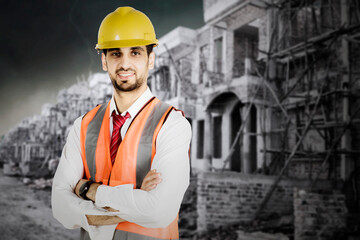 Male engineer folded hands near construction site
