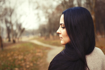 portrait of brunette woman with thick beautiful long hair close outdoor