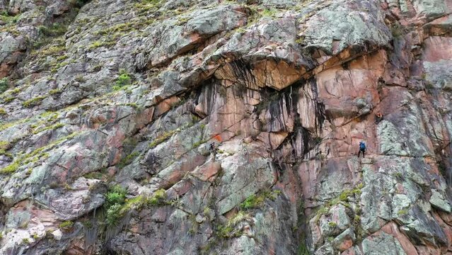 Drone shots of climbers at the Urubamba cliffs in Cusco, Peru. It is also known as the Sacred Valley. Climbers are climbing the mountain to their Airbnb. Shots are in Full HD