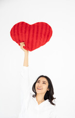 attractive asian female holding red heart figure, she feeling happy in valentine's day