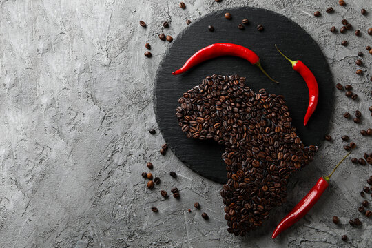 African continent made of coffee beans on gray textured background