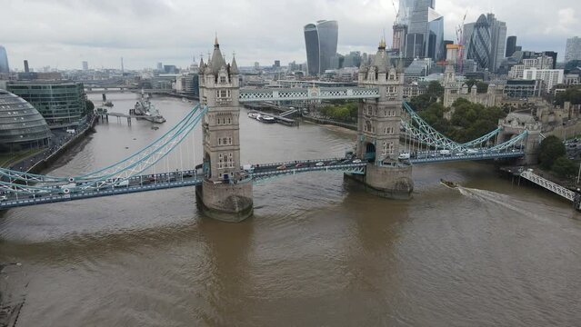 Aerial view of the London financial district, Tower Bridge and a boat navigating