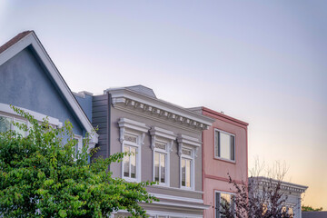 Townhouse with european style exterior with three reflective windows in San Francisco, California