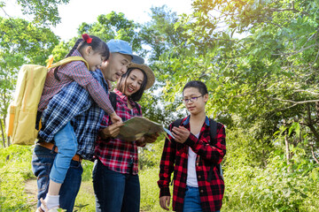 Group of Friends Asian Traveler Looking on the Map and Plan to Trekking and Adventure in the Forest - Travel in Holiday Summer Concept