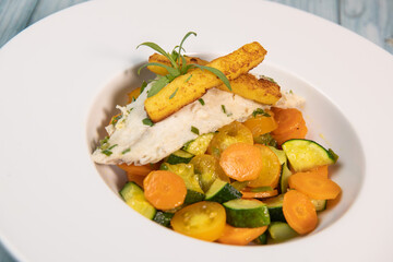 Fish recipe, fillet of sea bass with small vegetables, High quality photo