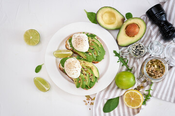 Freshly made poached egg and Avocado toasts on light grey background