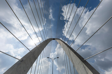 Low wide angle of Thu Thiem Two Bridge crossing the Saigon River in Ho Chi Minh City. It is the newest bridge in the economic capital. View is looking up to dramatic sky