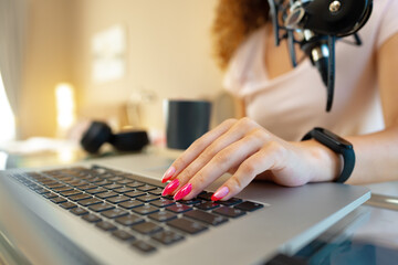 Close up of woman hands typing on laptop keyboard at the office