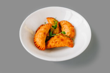 Fried Pies on plate on gray background.