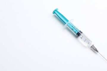 Fototapeta premium Medical syringe on a white background. A syringe for injection. The concept of health and beauty