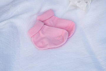 Pink socks for a newborn on a white background