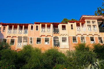 Fototapeta na wymiar Stone facade of old residential building in greek style
