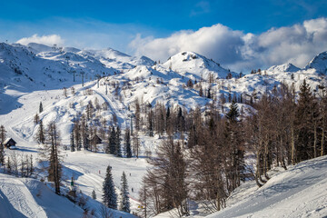 Fototapeta na wymiar Bohinj, Slovenia - Vogel ski resort in Bohinj in Julian Alps on a sunny winter day with blue sky and clouds