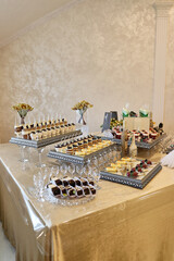 Festive sweet table. Cakes, cookies, fruits and mousses. Buffet table