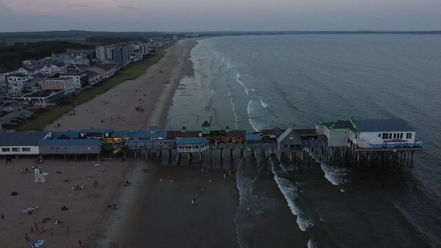A popular pier for dining at Old Orchard Beach in Maine at dusk in August.
