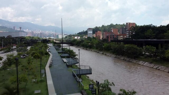 Aerial reveal of Medellin Colombia buildings from River Park (Parques del Rio)