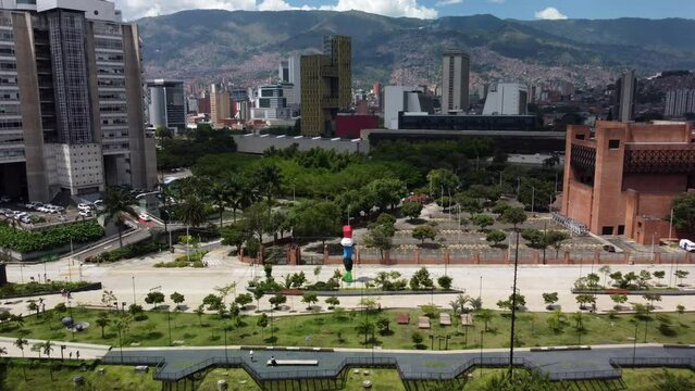 Aerial view of the colorful stacked stones in river park (Parques del rio)  Medellin Colombia with buildings in the background