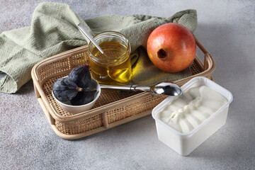 Ice cream, pomegranate, fresh figs and honey on the table