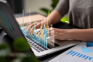 Close up shot of females hands typing on laptop for plan business growth at home office.