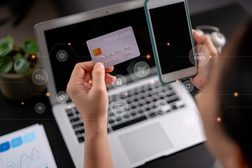 Close up shot of females hands holding credit card tand smart phone with technology icons.
