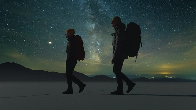 The two travelers walking on a starry sky background. slow motion