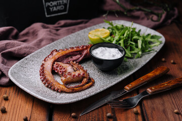 Traditional french octopus braised cooked with salicornia, lemon curd and spice