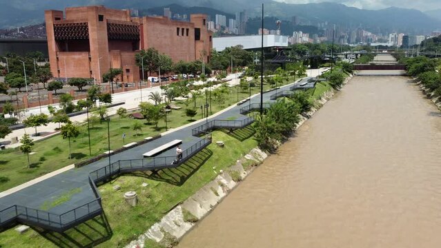 Aerial View of river park (Parques Del Rio) in downtown Medellin Colombia with building in the background