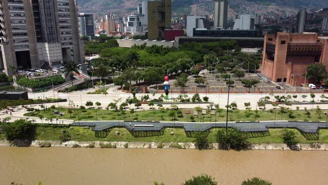 Aerial view of the colorful stacked stones in river park (Parques del rio)  Medellin Colombia with buildings in the background