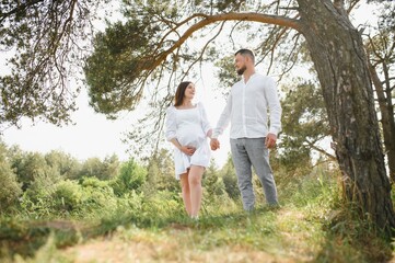 Pregnant woman with her family looking happy