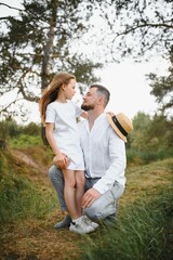 Fototapeta premium happy father and daughter playing while walking in a beautiful summer park. Ideal weekend father with his little daughter.