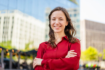 Happy woman with arms crossed wearing red shirt
