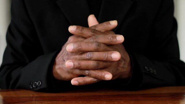 man praying to god with hands together on black background stock footage