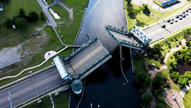 Aerial View Of Drawbridge Across Intercoastal waterway In Chesapeake Closing. Tilt Down
