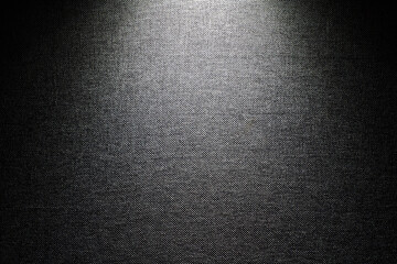 The gray background of the fabric is illuminated by a lantern from above