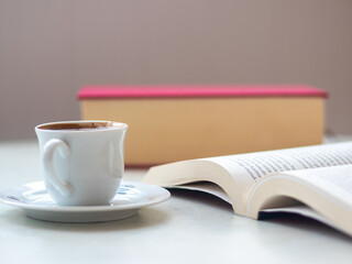 cup of turkish coffee and  open book