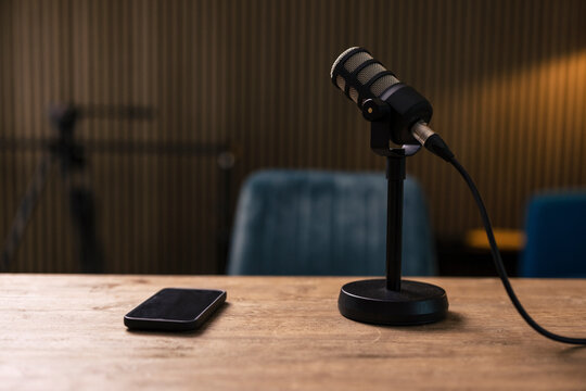 Smart phone by microphone on desk in recording studio